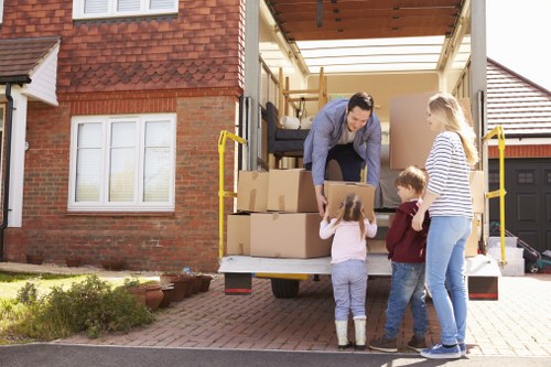 Loading furniture and boxes into a moving van in Maidahill