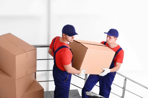 Moving team beginning a Maidahill removals job with packed boxes
