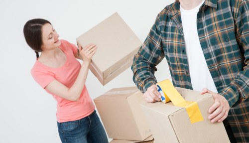 Packed moving boxes and furniture ready for collection in Maidahill
